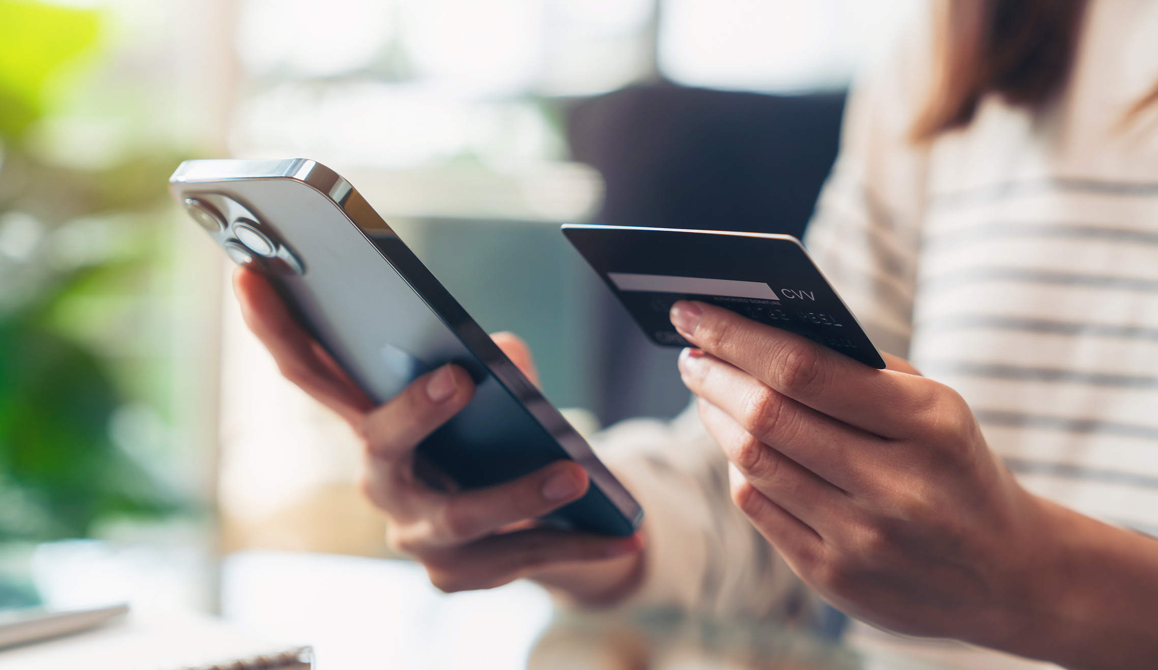 Woman entering credit card information on phone