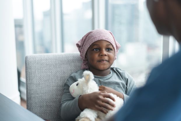 Little boy sitting across from his doctor